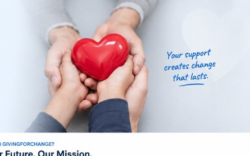 Hands supporting a heart to represent charitable giving